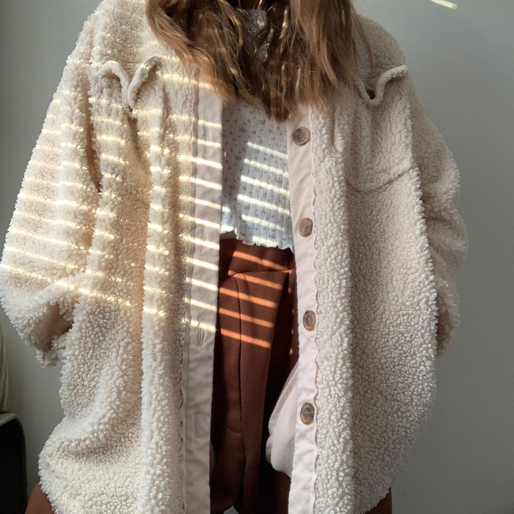 Fuzzy creme colored button-up jacket.